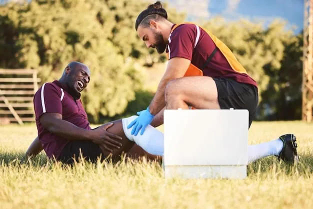 Close-up shot of a team doctor tending to a player on the field during a Champions League match. The player is visibly in discomfort, and the doctor is focused and concerned. The background is slightly blurred to draw attention to the medical attention being administered.
