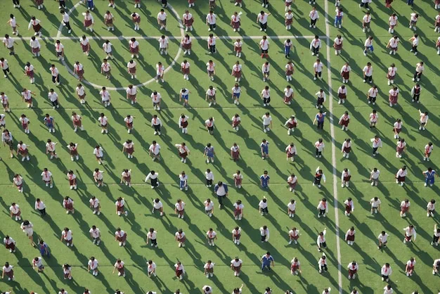 An aerial view of a La Liga team celebrating a goal, with players embracing each other near the corner flag. The scene captures the excitement and teamwork within the squad.