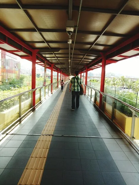 A photo showcasing modern infrastructure around a La Liga stadium, including pedestrian walkways, public transportation access points, nearby shops and restaurants, and well-maintained green spaces, indicating urban development resulting from the stadium's presence.