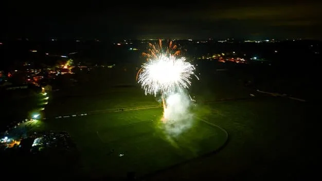 Aerial view of an MLS stadium during a night game, with fireworks exploding above the field and the crowd cheering. The stadium is brightly lit, and the scene captures the excitement and energy of a major sporting event.