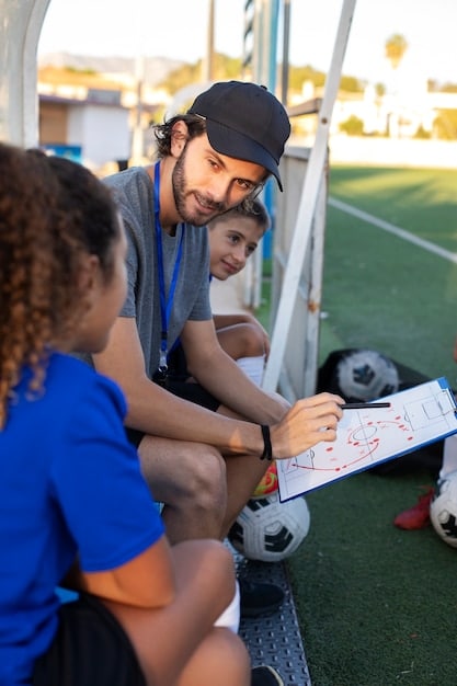 A La Liga team's coach intensely strategizing on the sidelines during a match, using a tactical board to illustrate plays to his players. The coach's animated gestures and the players' attentive expressions should highlight the importance of in-game adjustments.