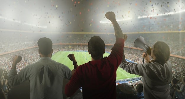 A close-up action shot of a La Liga forward skillfully dribbling the ball past a defender during a match. The background shows a blurred stadium with enthusiastic fans.