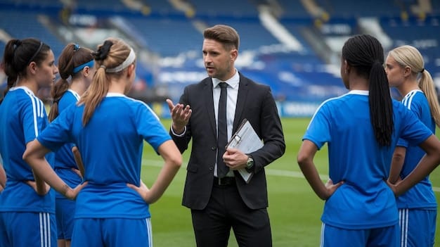 A medium shot of a team manager in La Liga giving instructions to his players during a training session. The manager is animated and passionate.