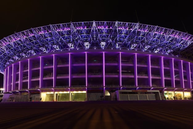 A wide shot of Villarreal's stadium, El Madrigal, during a night match. The stadium is illuminated brightly and the crowd is cheering.