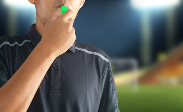 A close-up shot of an MLS academy coach instructing a player on the field, highlighting the personalized attention and skill refinement.