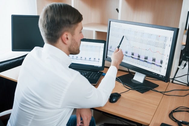 A data scientist working at a computer, analyzing soccer player statistics on a large monitor in a modern, brightly lit office. The monitor displays charts and graphs related to player performance.