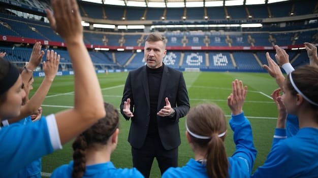 A coach intensely watching a soccer game from the sidelines, gesturing with his hands while communicating with his assistant. The focus should be on his focused expression and the strategic tension of the moment.