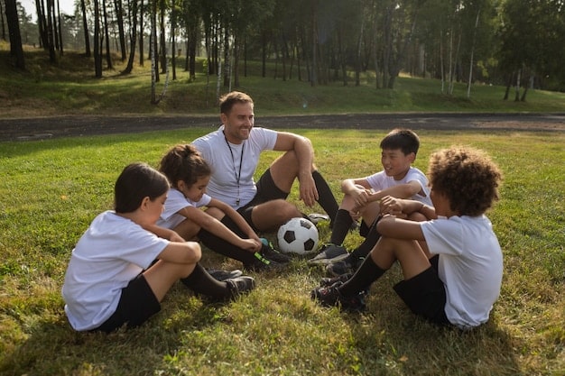 A group of young soccer players training on a field, with a coach guiding them. The image should convey a sense of teamwork, dedication, and skill development.