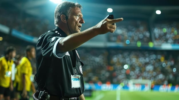 Action shot of a soccer referee consulting with the VAR monitor during a Champions League match, stadium and players blurred in the background